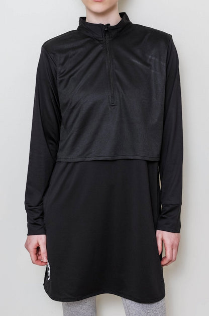 Person wearing a black long-sleeve athletic top  on a white background